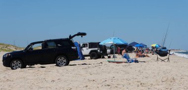 Dewey Beach, Delaware, U.S.A - August 13, 2022 - The trucks with tags parked on the surf fishing beach