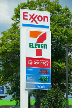 Nashville, Tennessee, U.S.A - June 26, 2022 - The colorful sign of Exxon gas station combined with 7 Eleven