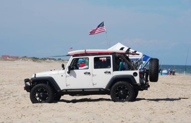 Dewey Beach, Delaware, U.S.A - September 3, 2022 - A white Jeep Wrangler parked on the beach