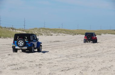 Dewey Beach, Delaware, U.S.A - September 3, 2022 - Two Jeep Wrangler driving on the beach