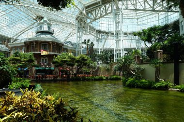 Nashville, Tennessee, U.S.A - June 26, 2022 - The buildings surrounded by tropical plants inside of Gaylord Opryland Resort and Convention Center