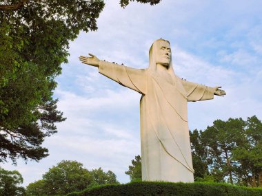 Eureka Springs, Arkansas, U.S.A - June 23, 2022 - The side view of Christ of the Ozarks statue during the day clipart