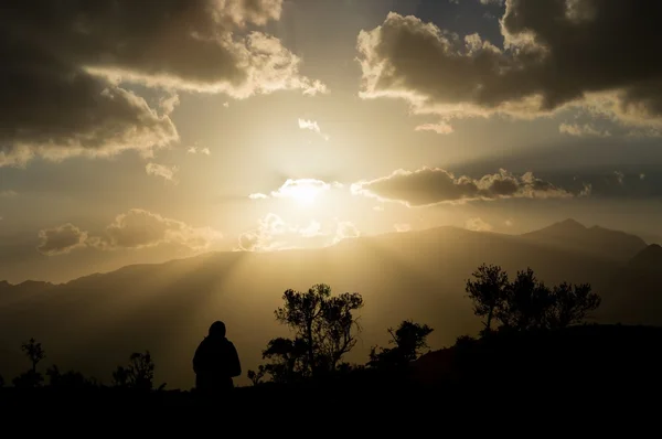 Solnedgång med silhuetten av en ensam person — Stockfoto