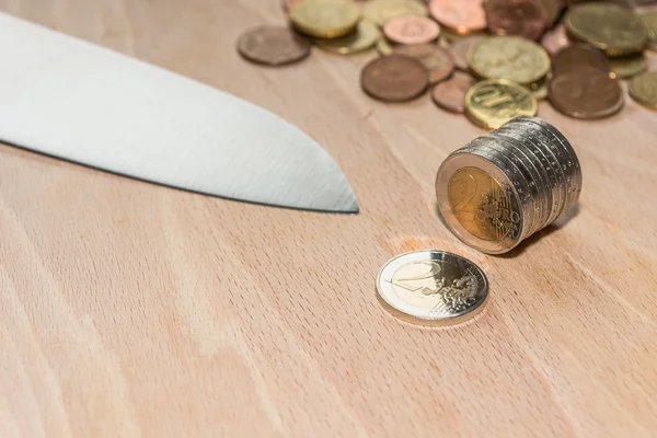 Knife cutting Euro coins — Stock Photo, Image