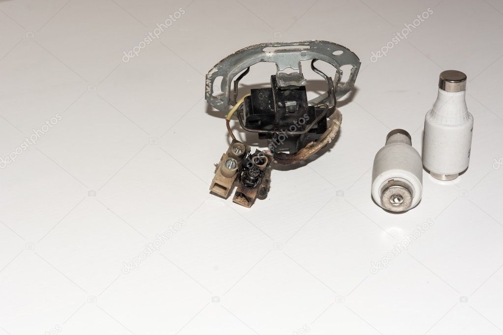 Damaged electrical socket with a pair of fuses
