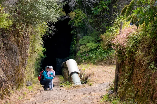 Mother and daughter posing at tunnel entrance before going through the mountain. — Stock Photo, Image