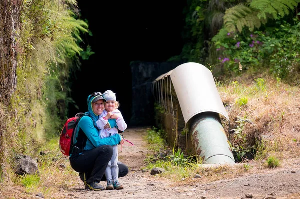 Mother and daughter posing at tunnel entrance before going through the mountain. — Stok fotoğraf