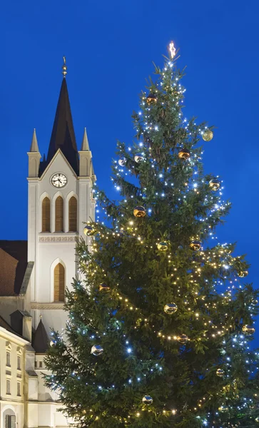 Christmas tree and church tower with blue sky — Stock Photo, Image