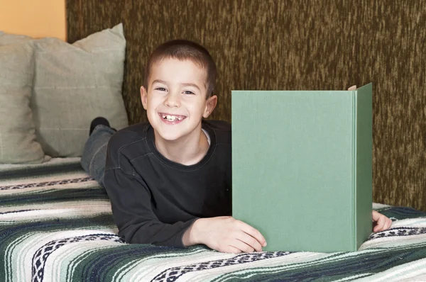 Rapaz feliz lendo livro — Fotografia de Stock