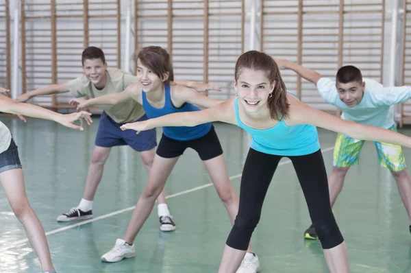 Teens in gymnasium — Stock Photo, Image