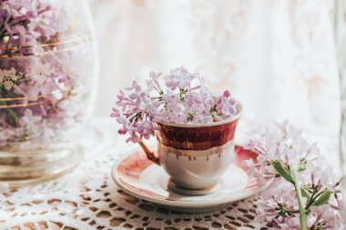 İçinde leylak çiçekleri olan Retro çay bardağı. Ev dekorasyonu. İlkbahar titreşimleri