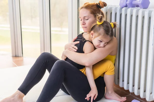 Young fit mom having loving time with her daughter