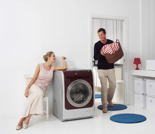Mulher e homem fazendo lavanderia — Fotografia de Stock