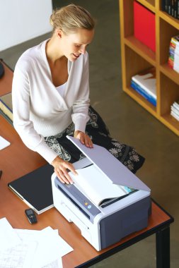 a businesswoman using copier machine clipart