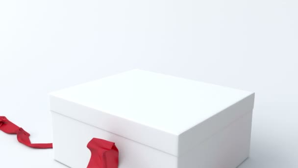 White, low gift box with red ribbon opening — Stock Video