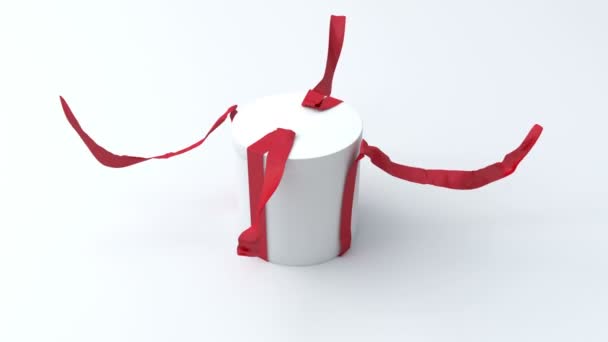 White gift in the shape of a cylinder with red ribbon opening — Stock Video