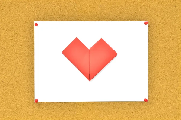 Cork board with red heart on paper — Stock Photo, Image