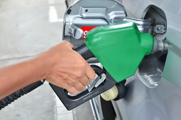 A man pumping gas in to the tank — Stock Photo, Image