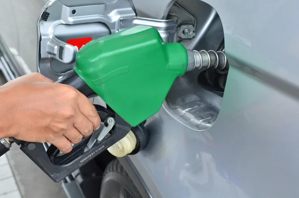 A man pumping gas in to the tank — Stock Photo, Image