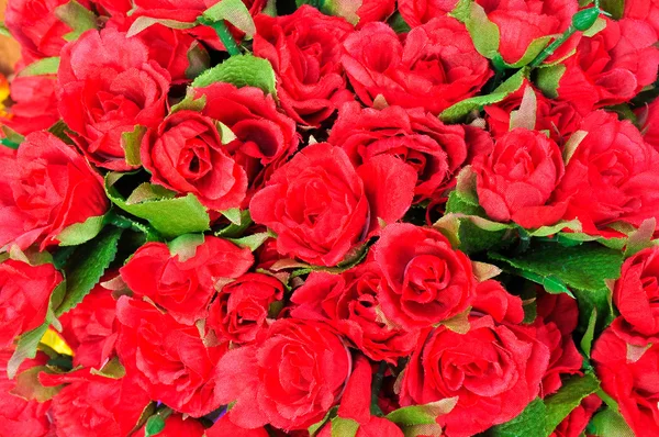 Artificial red rose flowers background — Stock Photo, Image