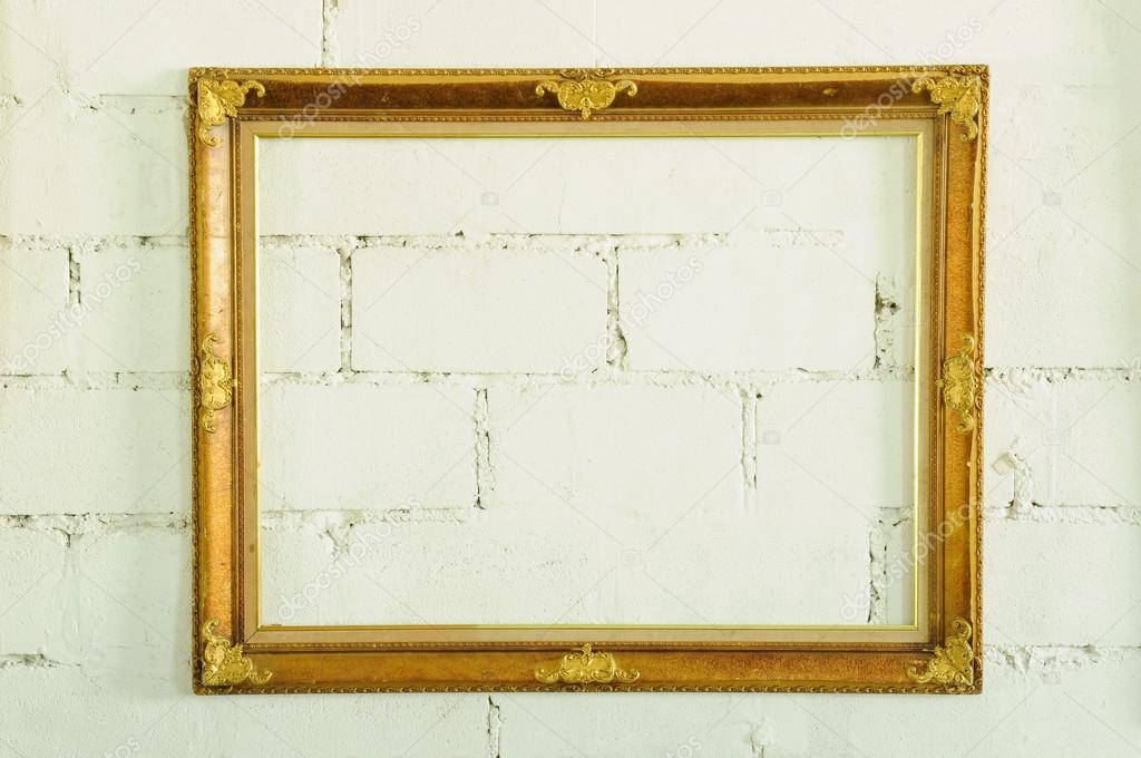Vintage gold picture frame on white wall