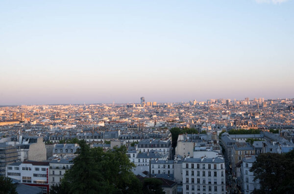 Paris European capital city rooftops view from high hill of Montmartre, aerial panoramic view on summer evening, cityscape