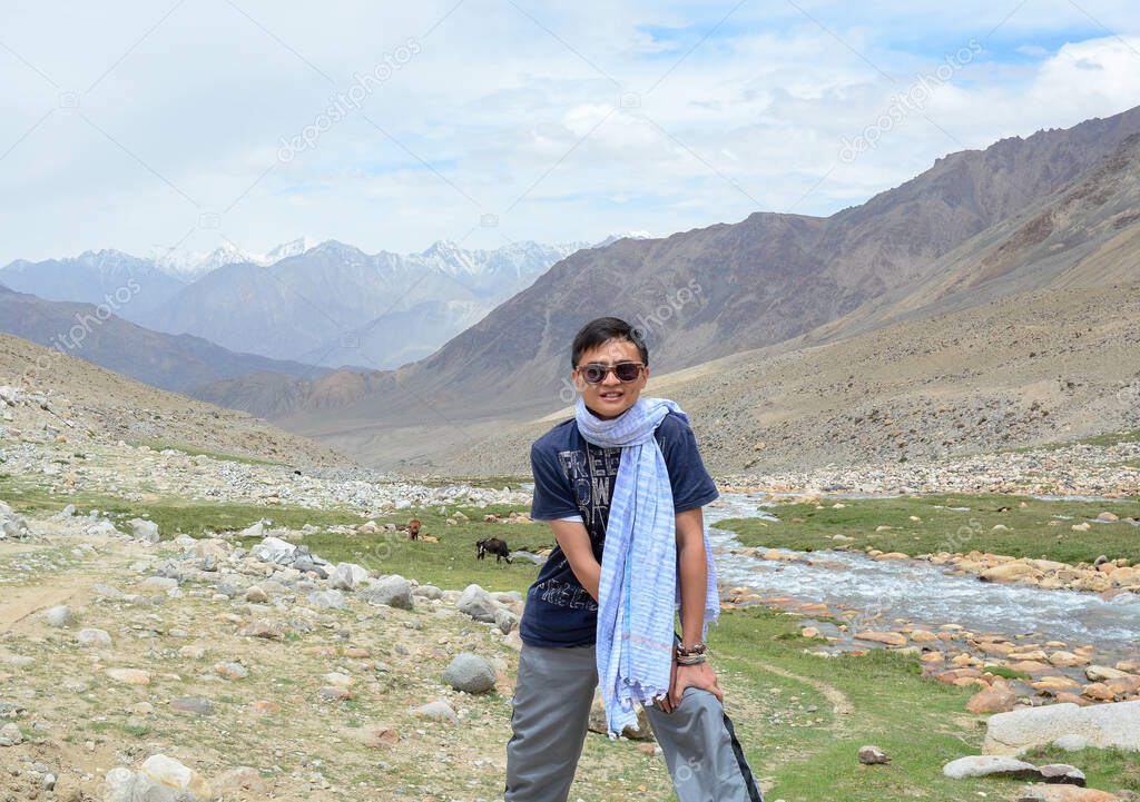 Asian traveler standing on mountain in Ladakh, State of Jammu & Kashmir, northern India.