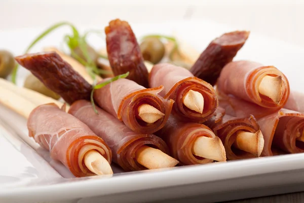 Breadsticks with smoked ham — Stock Photo, Image