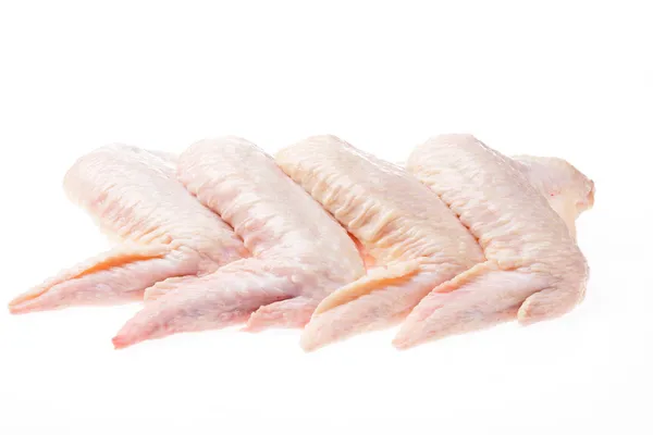 Сырые куриные крылья на белом фоне изолированы Лицензионные Стоковые Фото