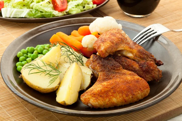 Roasted chicken wings with young potatoes — Stock Photo, Image