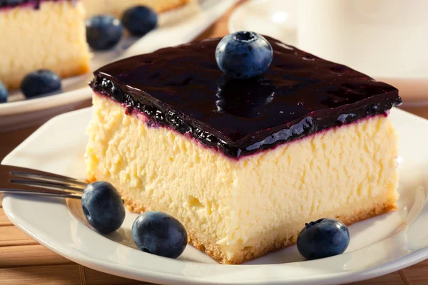 Cheesecake with blueberries and a cap of coffee — Stock Photo, Image