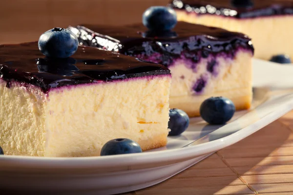 Cheesecake with blueberries and a cap of coffee — Stock Photo, Image