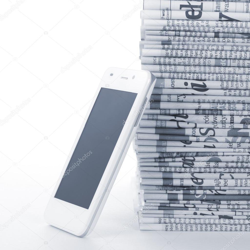 Phone and Newspapers folded and stacked concept