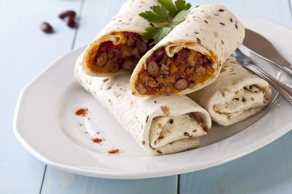 Burritos wraps with meat beans and vegetables — Stock Photo, Image