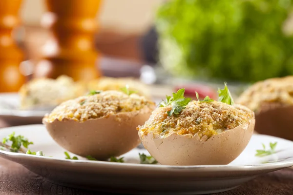 Baked eggs, stuffed with ham and parsley — Stock Photo, Image