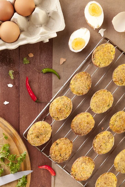 Baked eggs, stuffed with ham and parsley — Stock Photo, Image