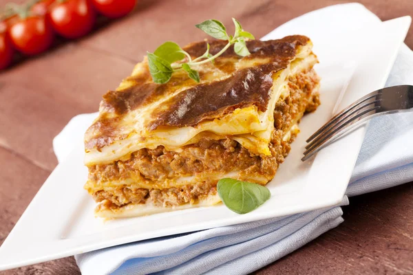 Portion of tasty lasagna on a plate — Stock Photo, Image