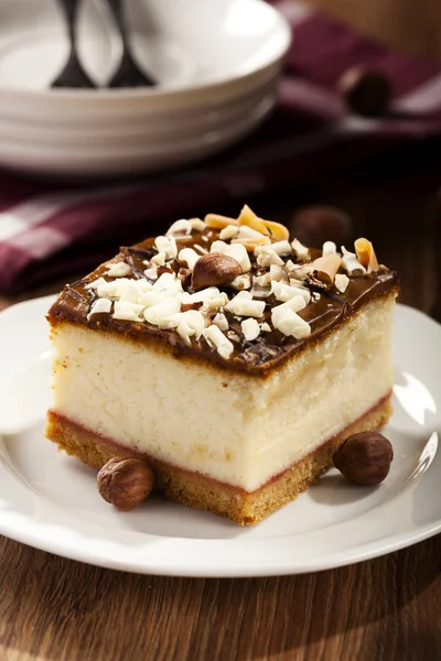 Cheesecake with nuts on plate — Stock Photo, Image