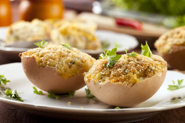 Baked eggs, stuffed with ham and parsley — Stock Photo, Image