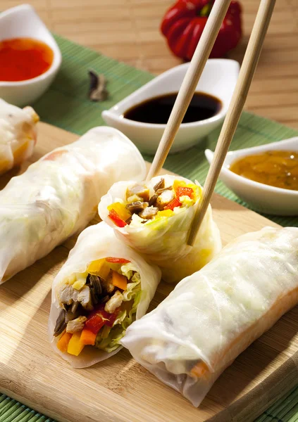 Portion of spring rolls on a bamboo board — Stock Photo, Image