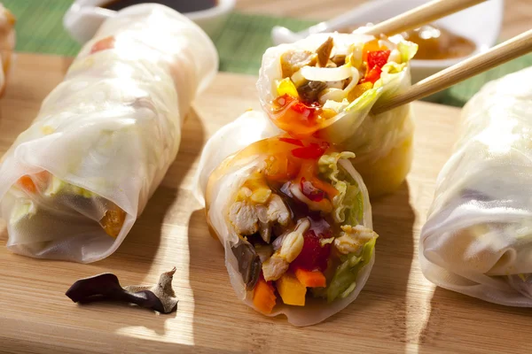 Portion of spring rolls on a bamboo board — Stock Photo, Image