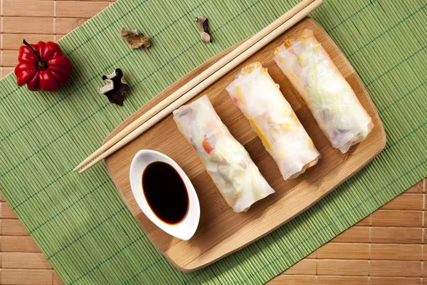 Portion of spring rolls on a bamboo board — Stock Photo, Image