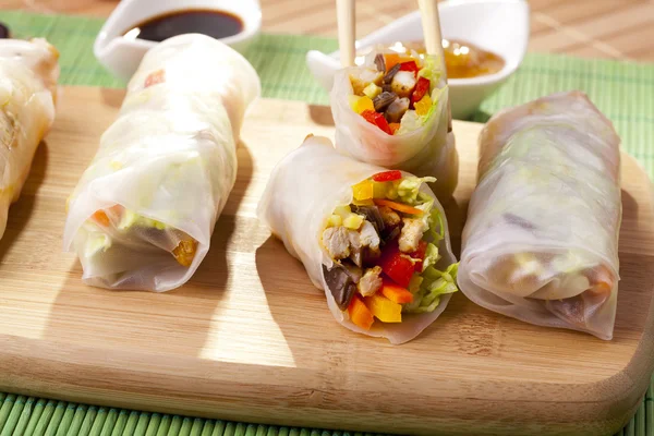 Portion of spring rolls on a bamboo board — Stock Photo, Image