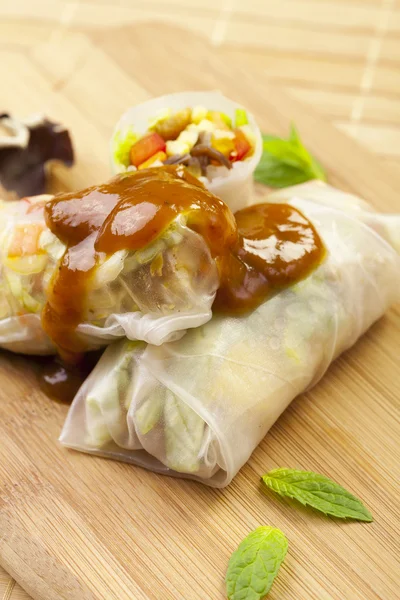 Portion of spring rolls on a bamboo board — Stock Photo, Image