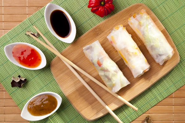 Portion of spring rolls on a bamboo board — Stock Photo, Image