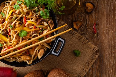 Mangolu kızarmış tavuk ve erişteli hindistan cevizi sütü. Bir tavada hazır. Üst görünüm. 