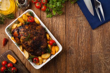 Patates, biber ve domatesle omuz omuza kavrulmuş. Beyaz şarapla marine edilmiş. Manzaralı. Doğal ahşap zemin. 