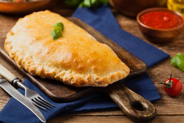 Mantarlı ve jambonlu İtalyan calzone. Ön görünüm. 