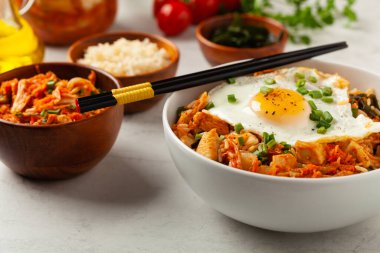 Pirinç ve tavuklu kimçi lahanası. Hafif mermer arka planda beyaz bir kasede servis edilmiş. Ön görünüm.