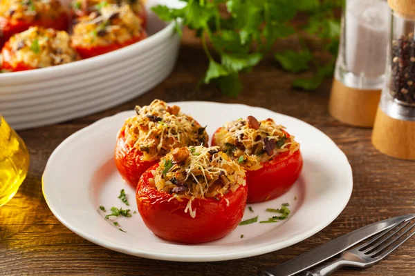 Baked stuffed tomatoes. Stuffed with chanterelles. Top view of the dish.